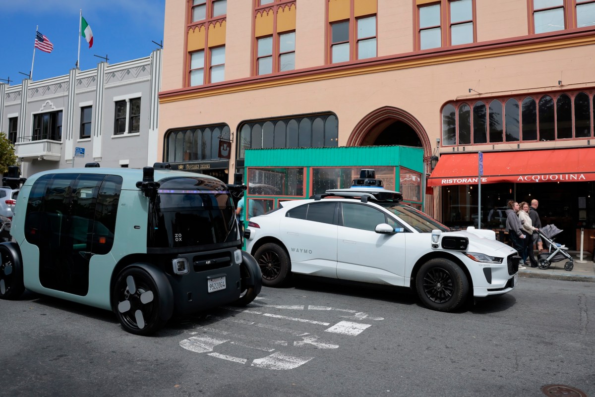 Autonomous robotaxi navigating a city street at dusk