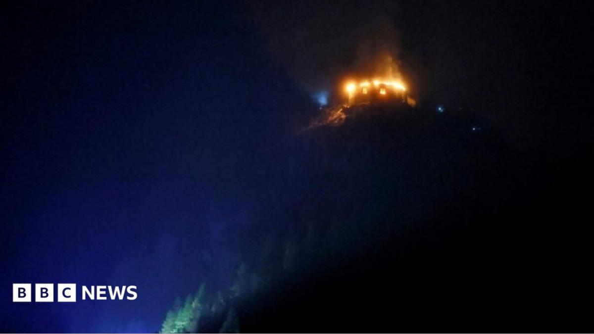 Eagle's Nest retreat on a German mountain ridge with smoke rising from a fire