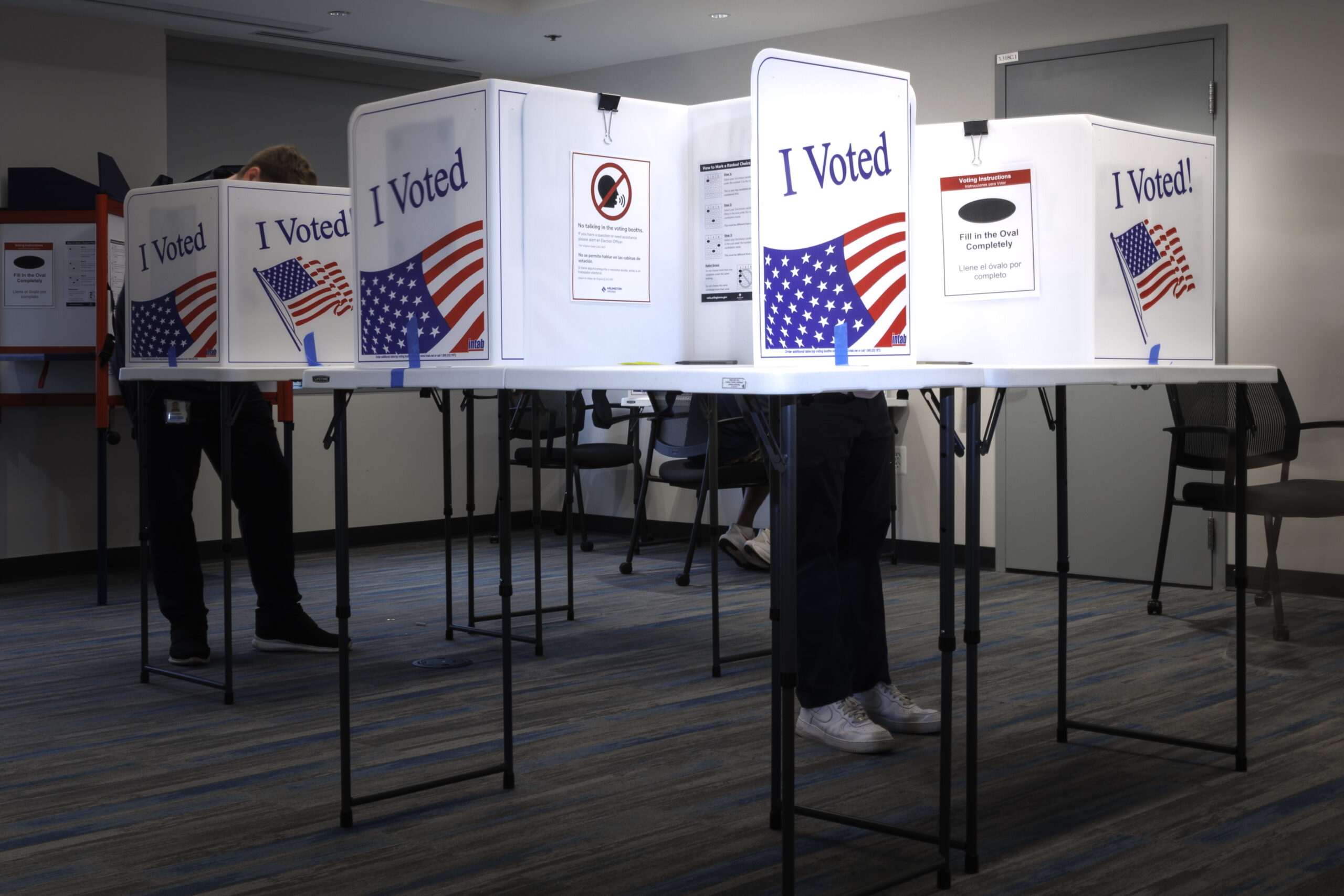 Polling station interior with voters lining up for the 2026 midterms
