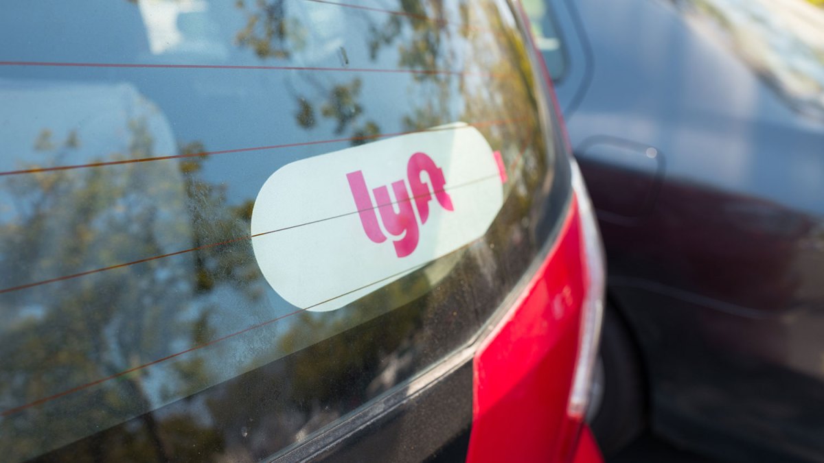 City street with rideshare vehicles at night, representing the gig‑economy landscape.