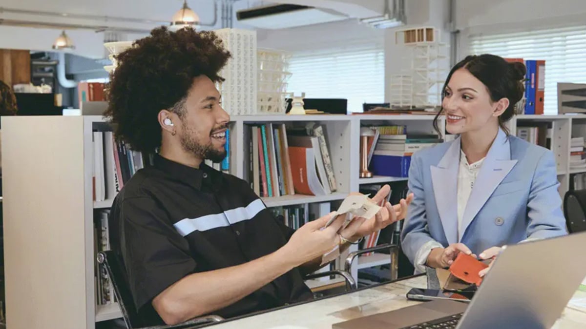 Sony LinkBuds Open earbuds on a desk with a smartphone