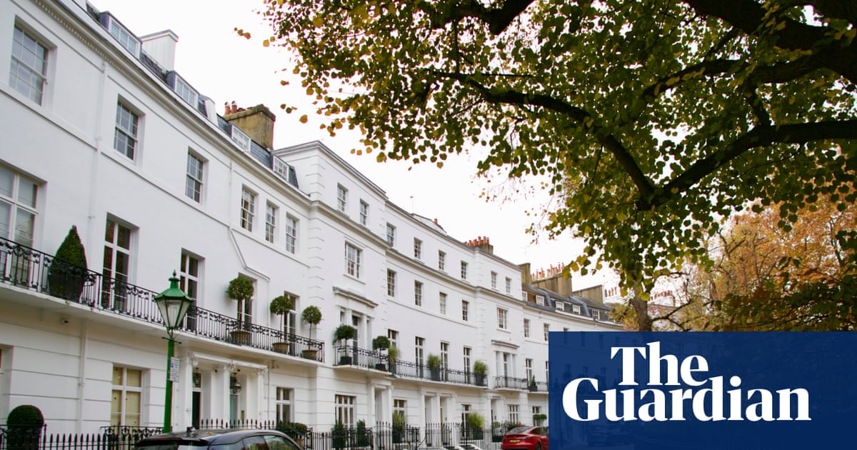 Row of historic Georgian townhouses on a quiet London street with ornate architecture and tree-lined pavement