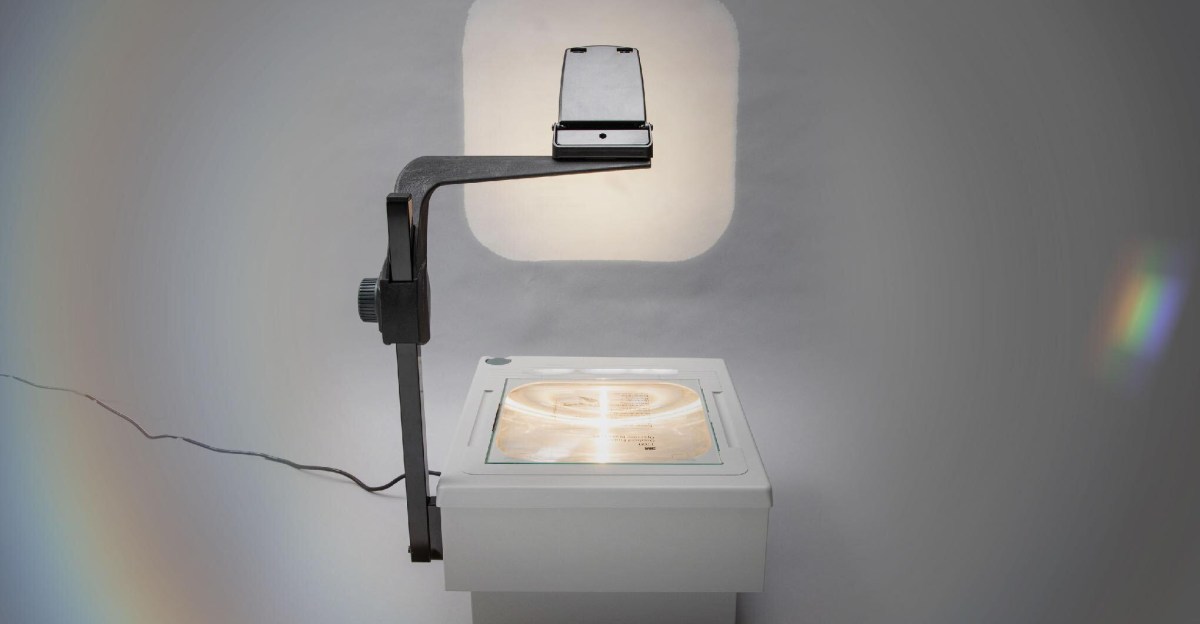 Overhead projector displaying a diagram in a contemporary classroom with attentive students.