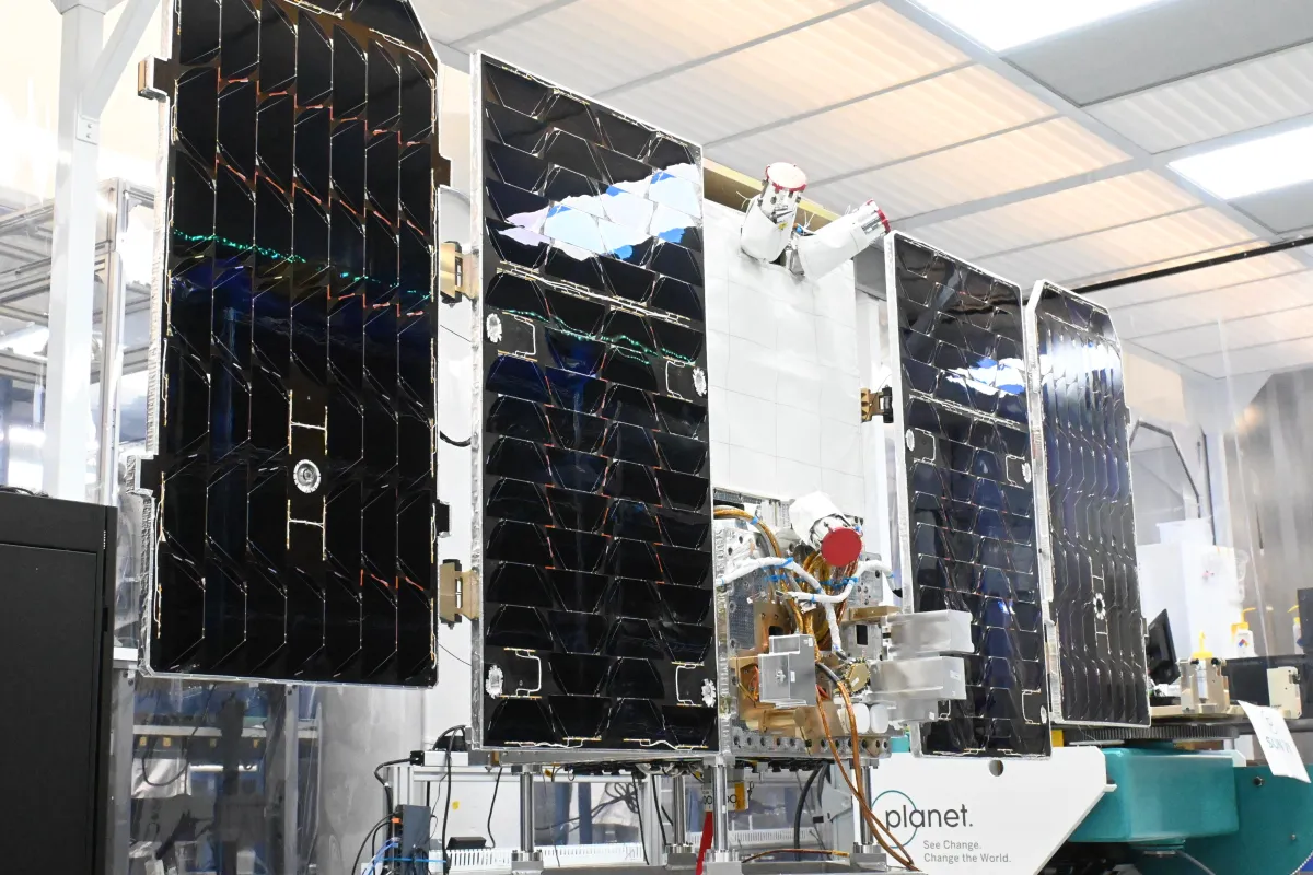 Satellite in space with AI-generated poetry text floating nearby against Earth's curvature.