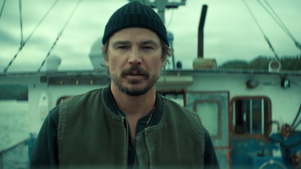 Stormy Newfoundland coast with a hint of a sea monster beneath the waves, evoking the mood of Netflix’s series “Below.”
