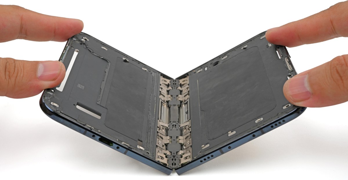 Foldable smartphone with a visible crack near the hinge on the inner screen