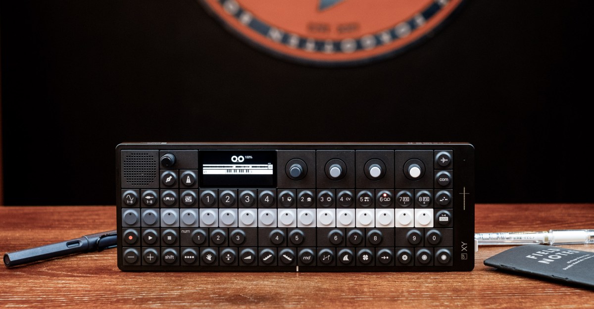 Teenage Engineering OP-1 synth parts and design sketches on a studio desk