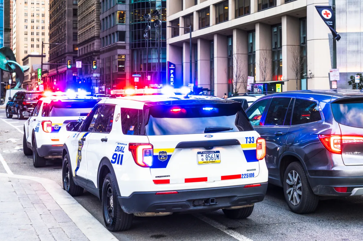 Police dispatch center with AI code on screens, representing a false AI tip incident