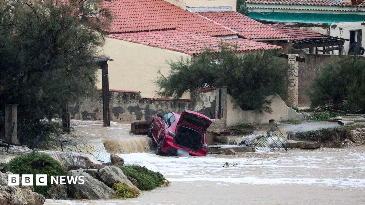 Flooded street in a southern French town under stormy skies